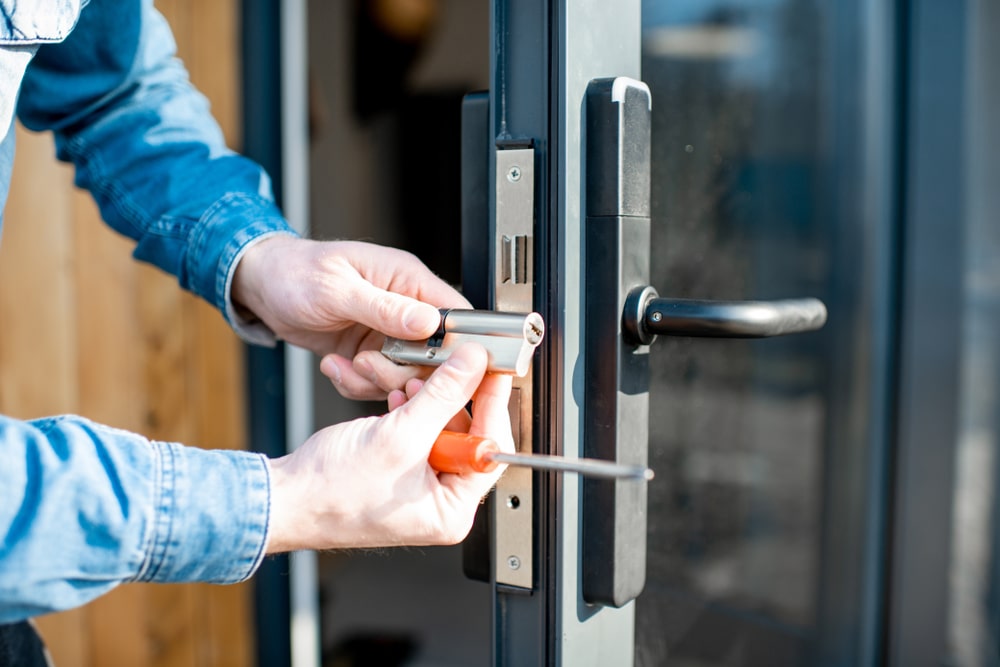 A man fixing a door lock